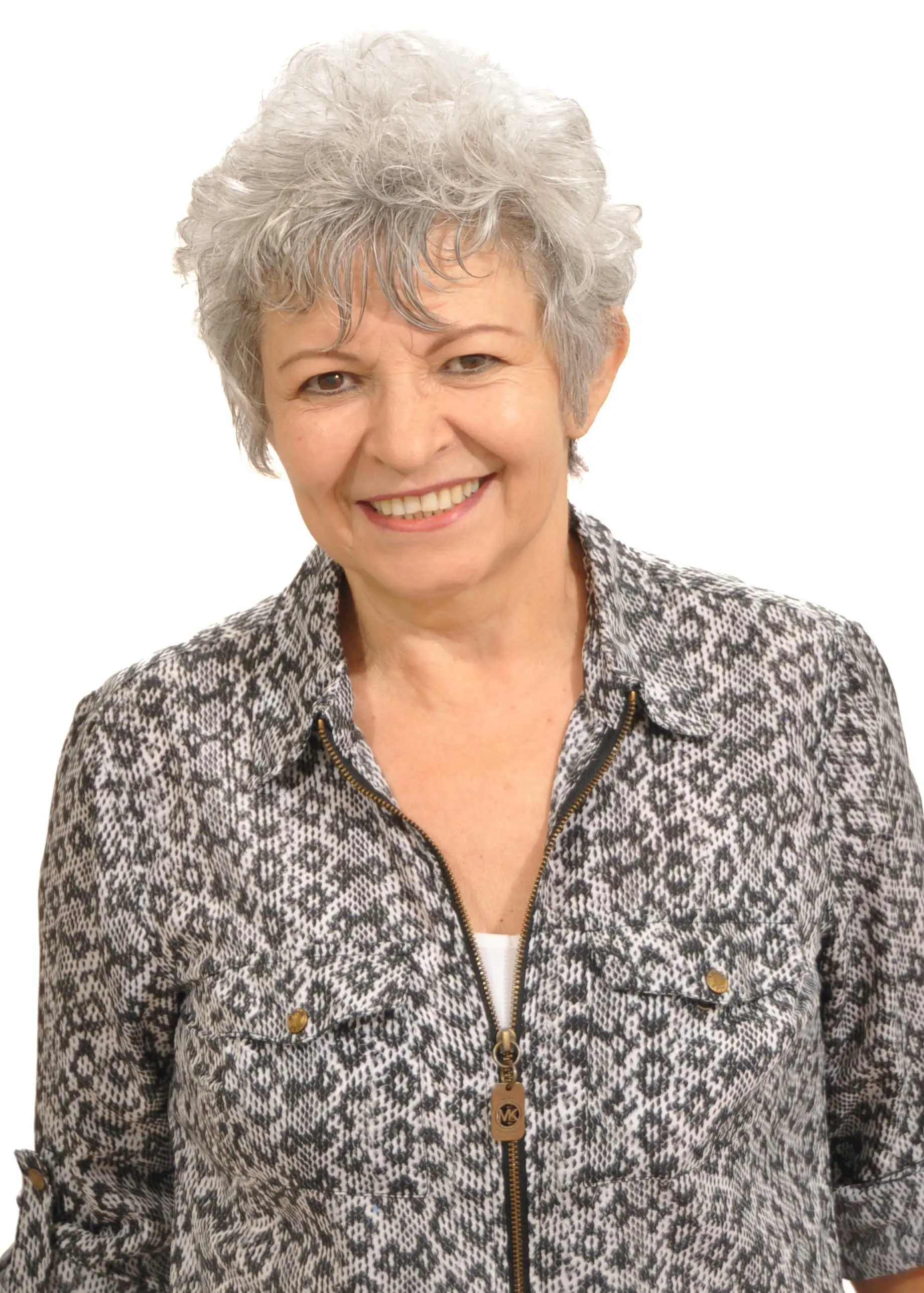Older woman smiling in patterned blouse staff photo