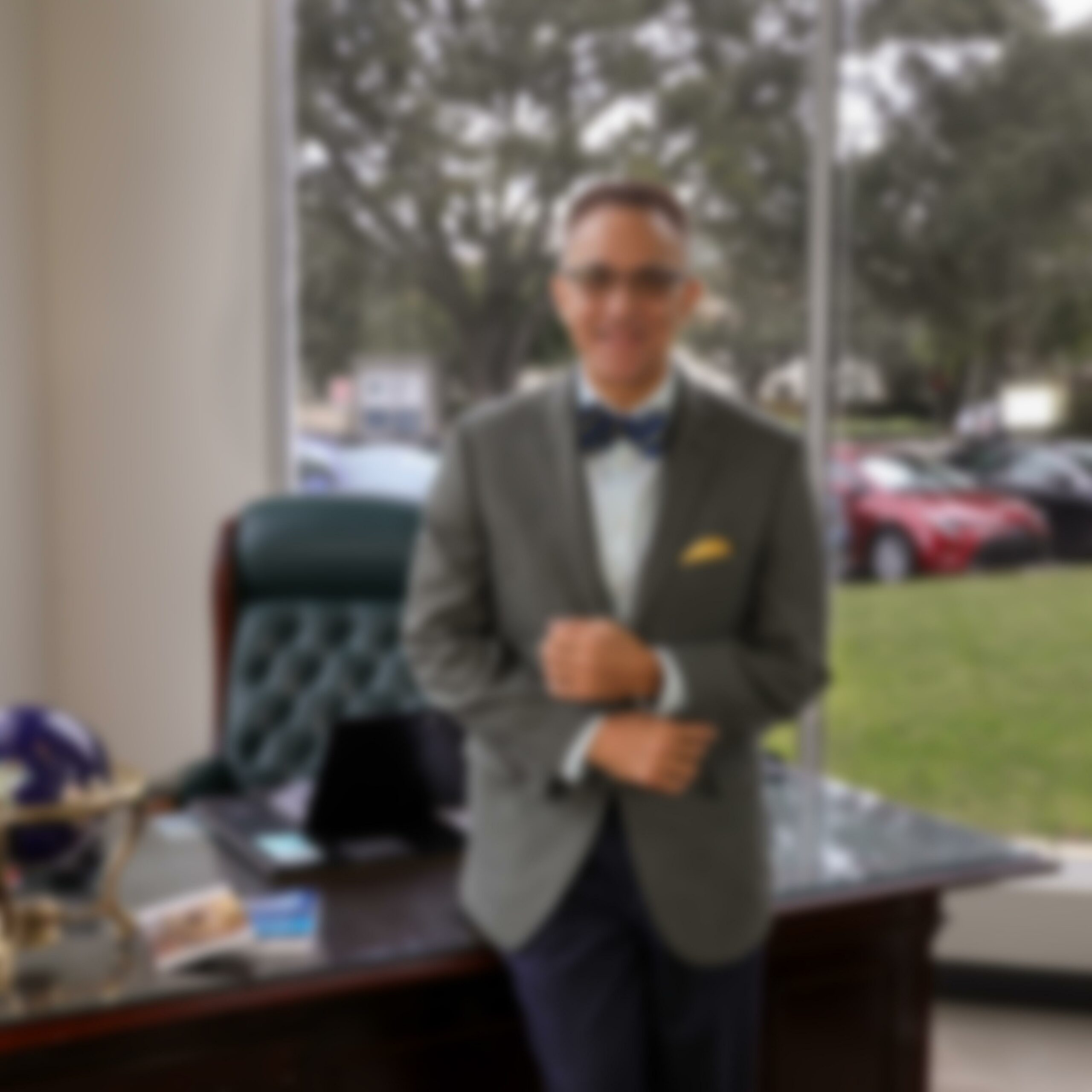 Frank Runnels standing in office FLCOE leadership blurred photo