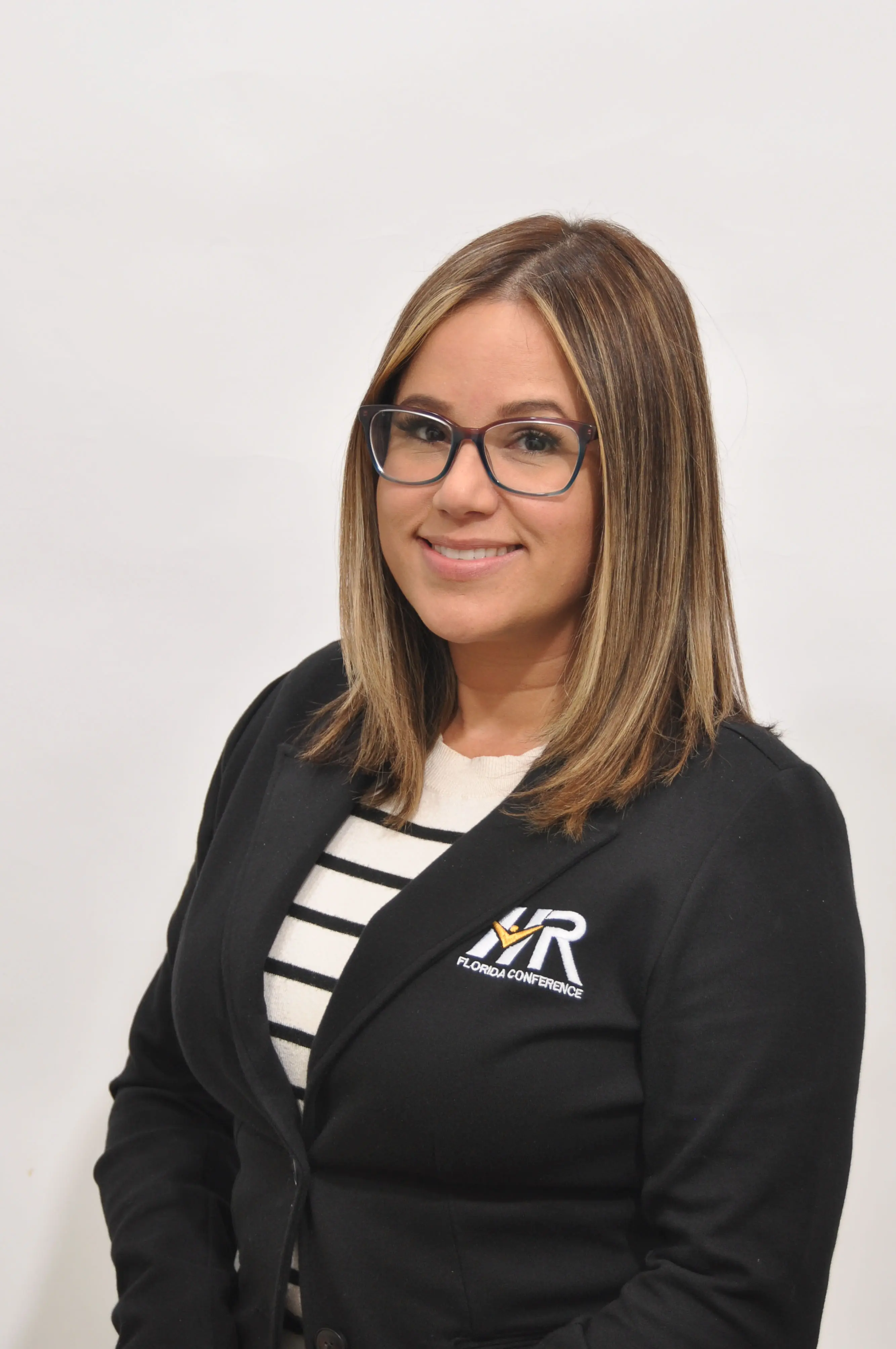 Woman smiling in professional headshot staff photo