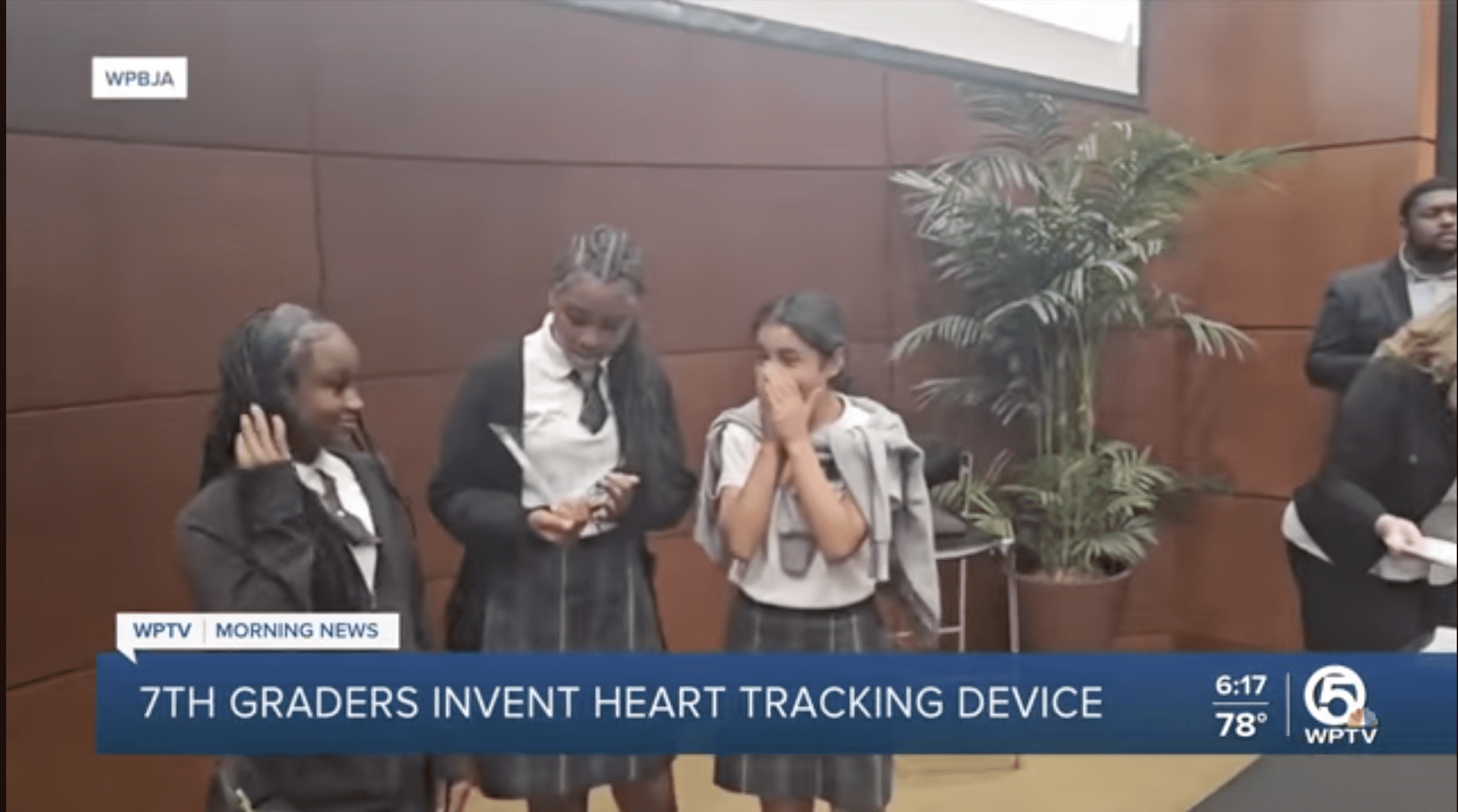 Middle school students presenting heart tracking invention